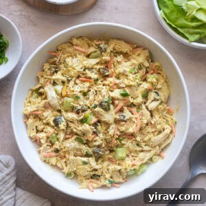Curry chicken salad in a serving bowl, garnished with fresh herbs and a hint of spice.