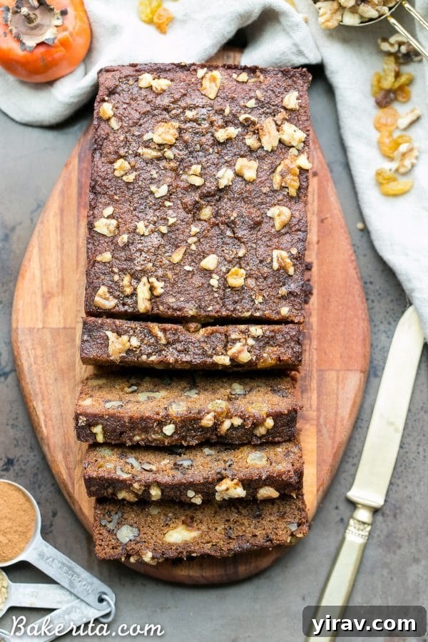 An overhead view of a perfectly sliced loaf of paleo persimmon bread.