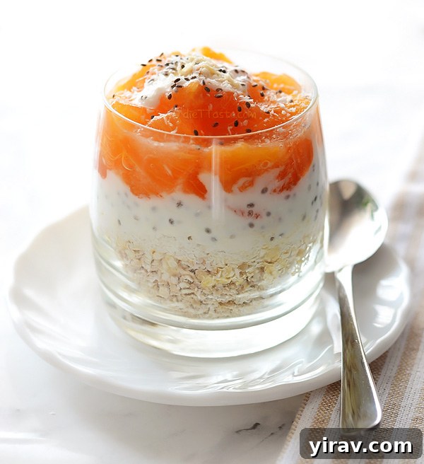 Persimmon coconut overnight oats served in a glass jar, showing layers of fruit and oats.