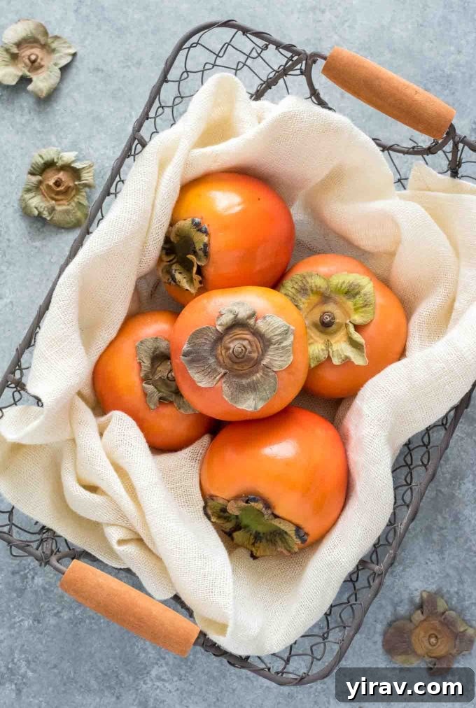 Close-up shot of a vibrant Fuyu persimmon nestled in a rustic woven basket, highlighting its smooth, orange skin.