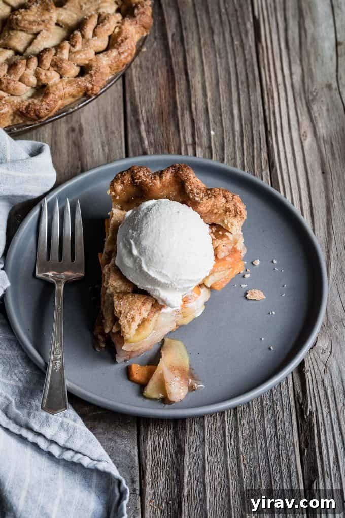 A slice of vanilla bean pear persimmon pie on a plate, revealing its delicious layers.