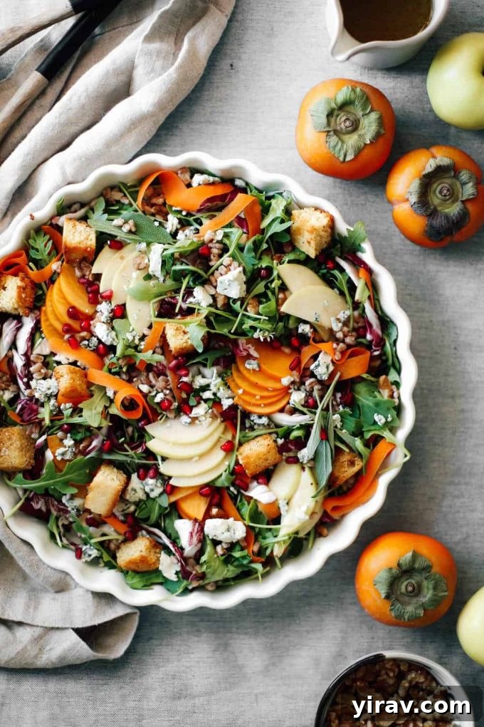 Apple and persimmon salad with Chinese 5 Spice Cornbread Croutons in a decorative bowl.