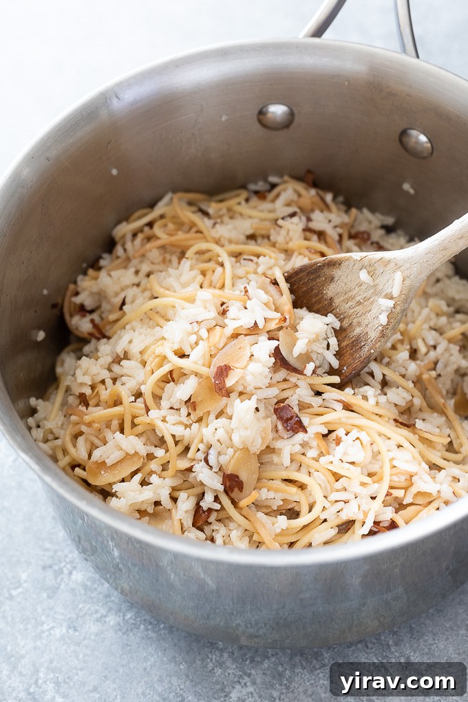 Wooden spoon in a pot of rice pilaf