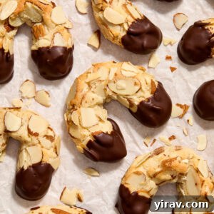 Almond horn cookies on parchment paper.