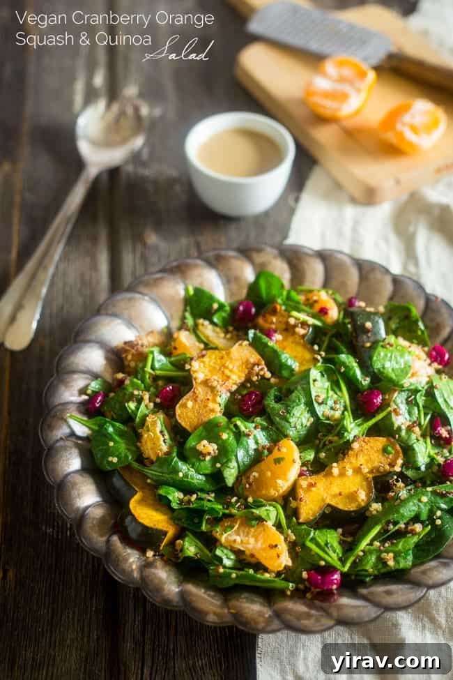 A serving dish filled with roasted acorn squash quinoa cranberry salad.