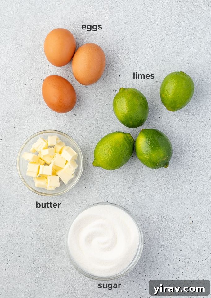 Ingredients for lime curd laid out on a table, including limes, eggs, butter, and sugar.