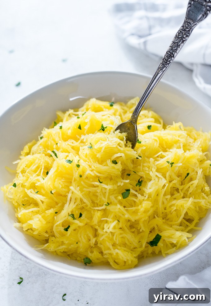Bowl of shredded spaghetti squash garnished with fresh parsley