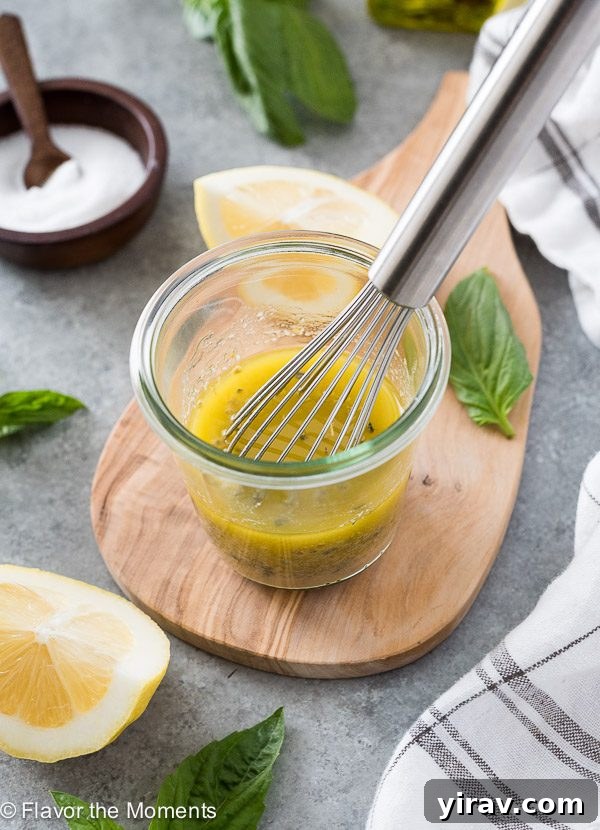 Jar of homemade Italian salad dressing with whisk