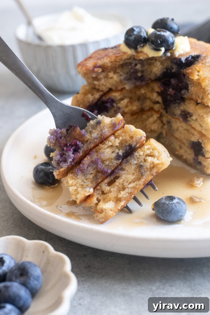 Forkful of Greek yogurt pancakes with blueberries.