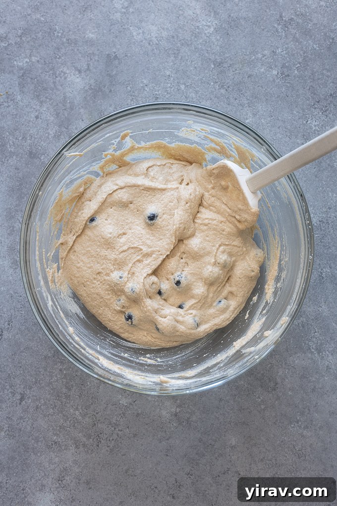 Greek yogurt pancake recipe batter with blueberries folded in.
