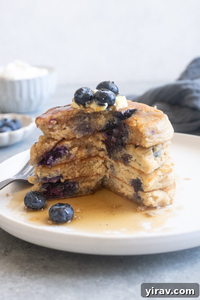 Stack of fluffy Greek yogurt pancakes on a plate.