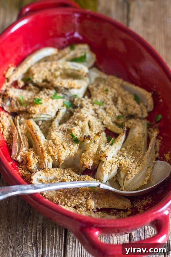 A delicious serving of Italian Parmesan Baked Fennel on a white plate.