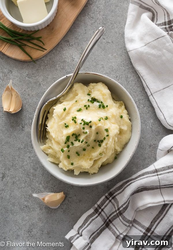 Quick and Creamy Instant Pot Mashed Potatoes 3 Overhead shot of creamy Instant Pot mashed potatoes in a serving bowl with a fork, ready to eat.