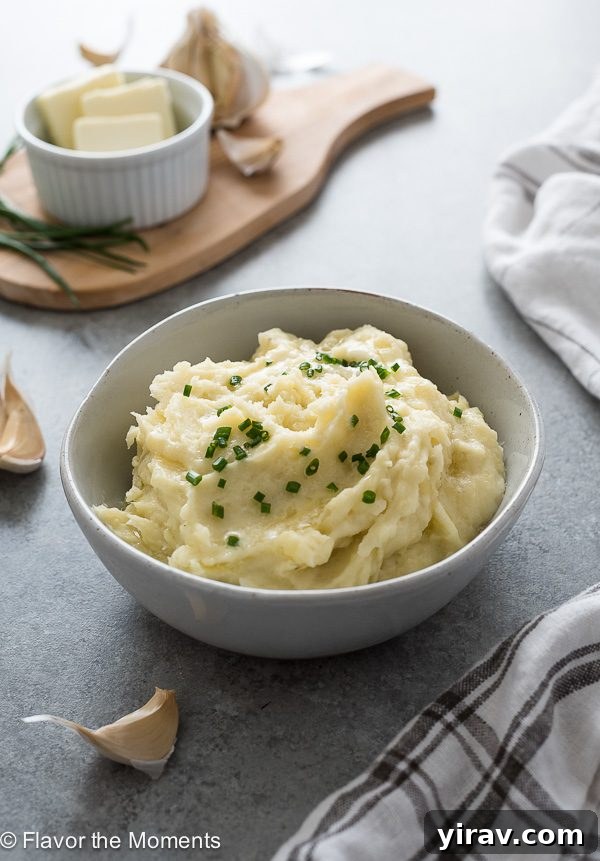 Quick and Creamy Instant Pot Mashed Potatoes 8 Instant Pot mashed potatoes in a bowl with fresh chives and a pat of butter melting on top, indicating its richness.