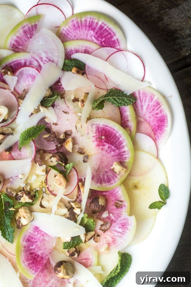 Radish and Apple Salad on a white plate, crisp and colorful.