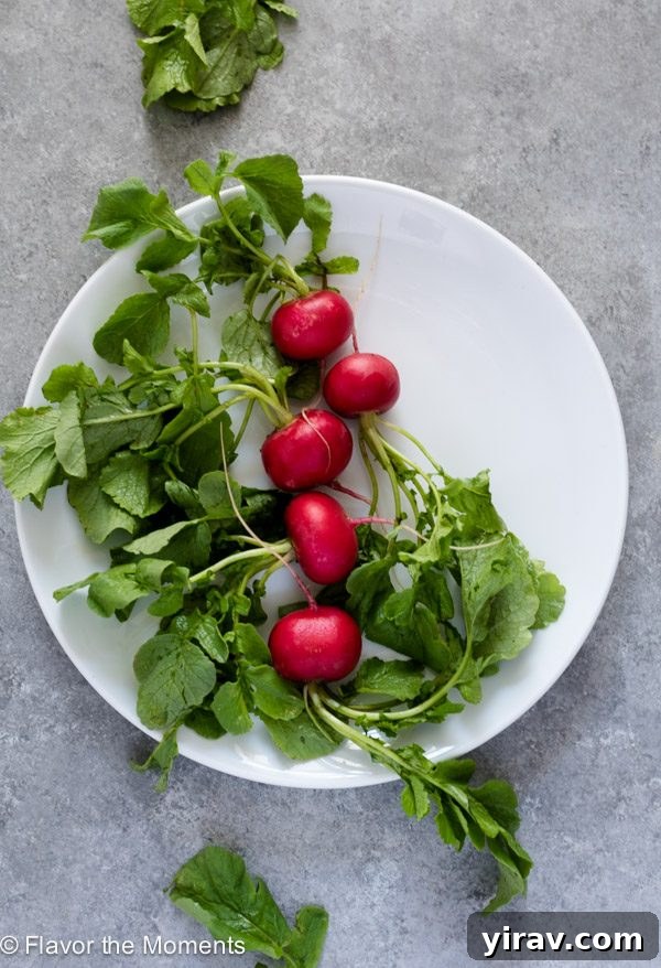 Radishes on a white plate, ready to be prepared for cooking or eating raw.