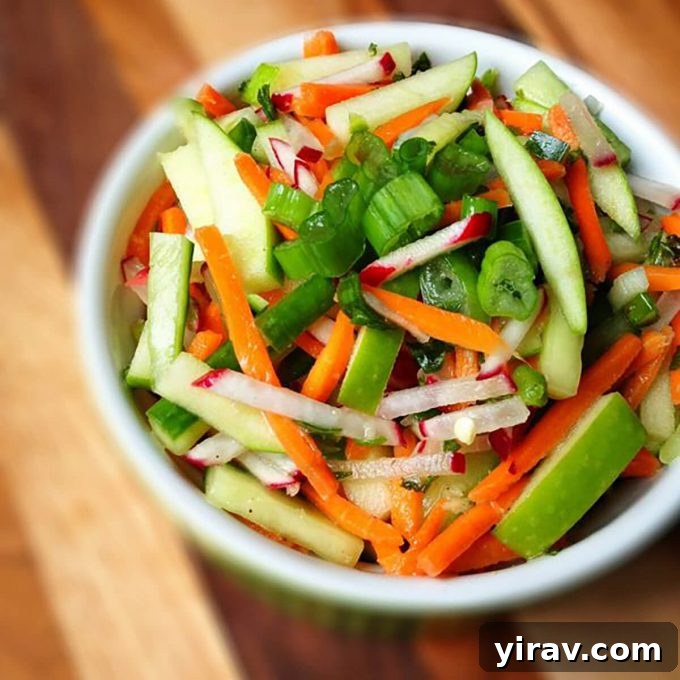 A white dish of apple radish slaw, a perfect side for any meal.