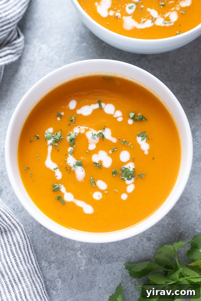 Golden Ginger Carrot Elixir 3 Carrot soup in a bowl with coconut milk and cilantro on top