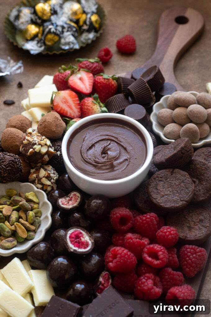 A close-up of a chocolate dessert board, prominently featuring a bowl of creamy chocolate ganache surrounded by an assortment of delicious treats, fresh fruits, and nuts, inviting guests to indulge.
