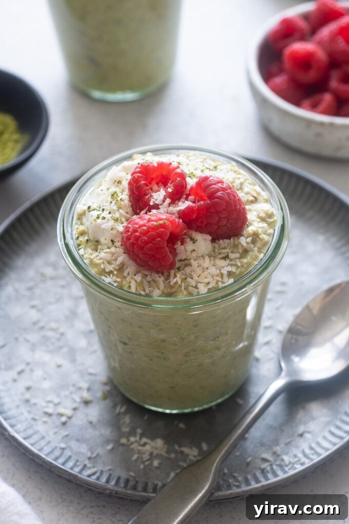 Matcha Morning Magic 2 Matcha overnight oats in a jar with raspberries on top.