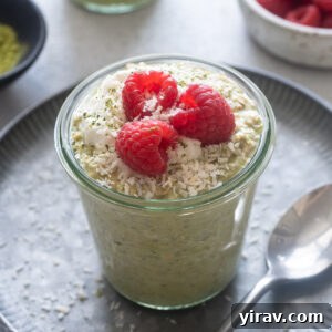 Matcha Morning Magic 10 Matcha overnight oats in a jar with raspberries on top.