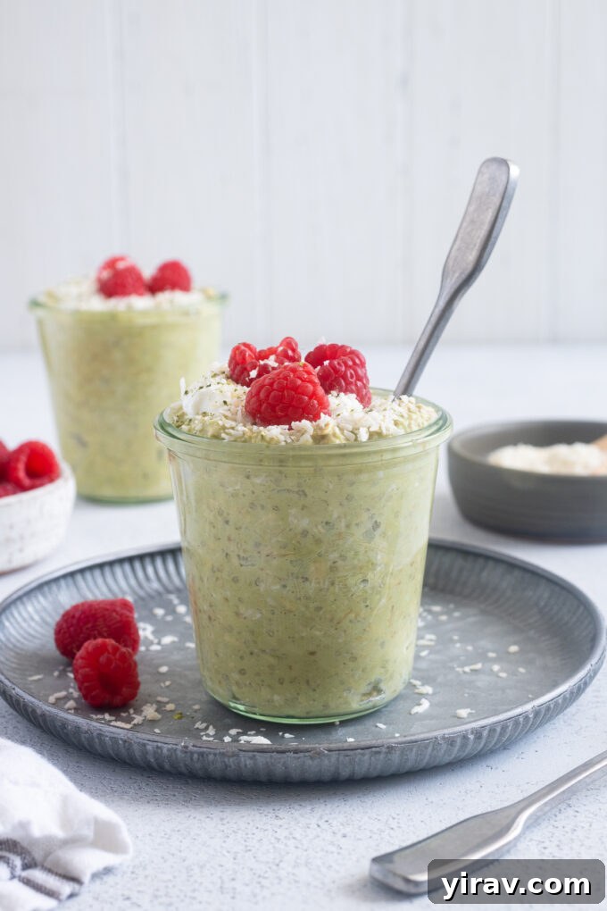 Matcha Morning Magic 3 Matcha coconut overnight oats in a jar with a spoon digging in.