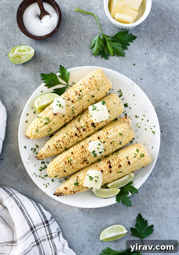 Grilled corn on the cob with melted butter and parsley