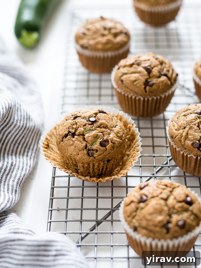 Gluten-free zucchini muffin with paper liner partially removed