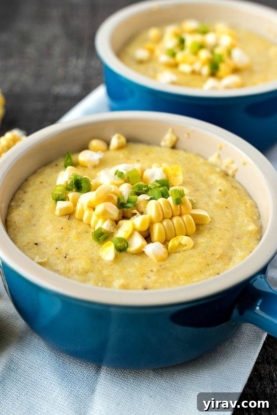 Two elegant blue ramekins filled with creamy Goat Cheese Sweet Corn Grits, ready to be served.