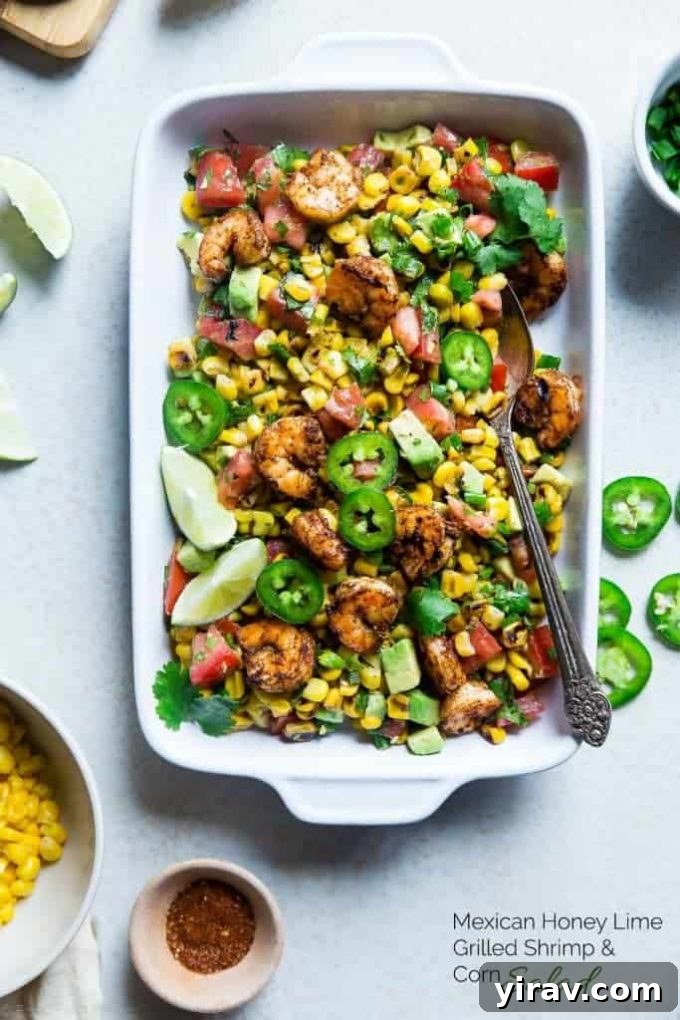A baking dish filled with Mexican Corn Salad with Honey Lime Shrimp, beautifully arranged.