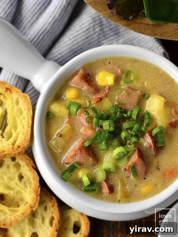 A white ramekin of comforting Sweet Corn, Kielbasa, and Potato Soup, ready to be enjoyed.