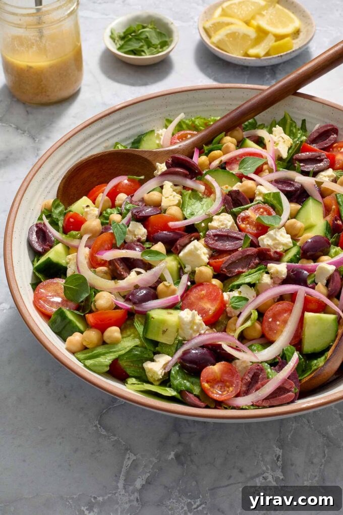 Vibrant Mediterranean Chop Salad 7 Close-up shot of Mediterranean salad with a serving spoon, highlighting the fresh, crisp ingredients.