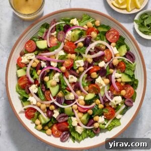 Vibrant Mediterranean Chop Salad 8 Mediterranean Chopped Salad in a bowl with a side of Greek dressing, ready to be served.