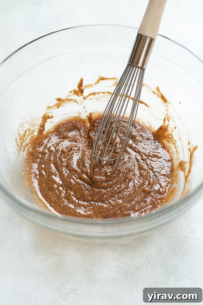 Step 1: Combine wet ingredients for almond butter granola in a bowl.