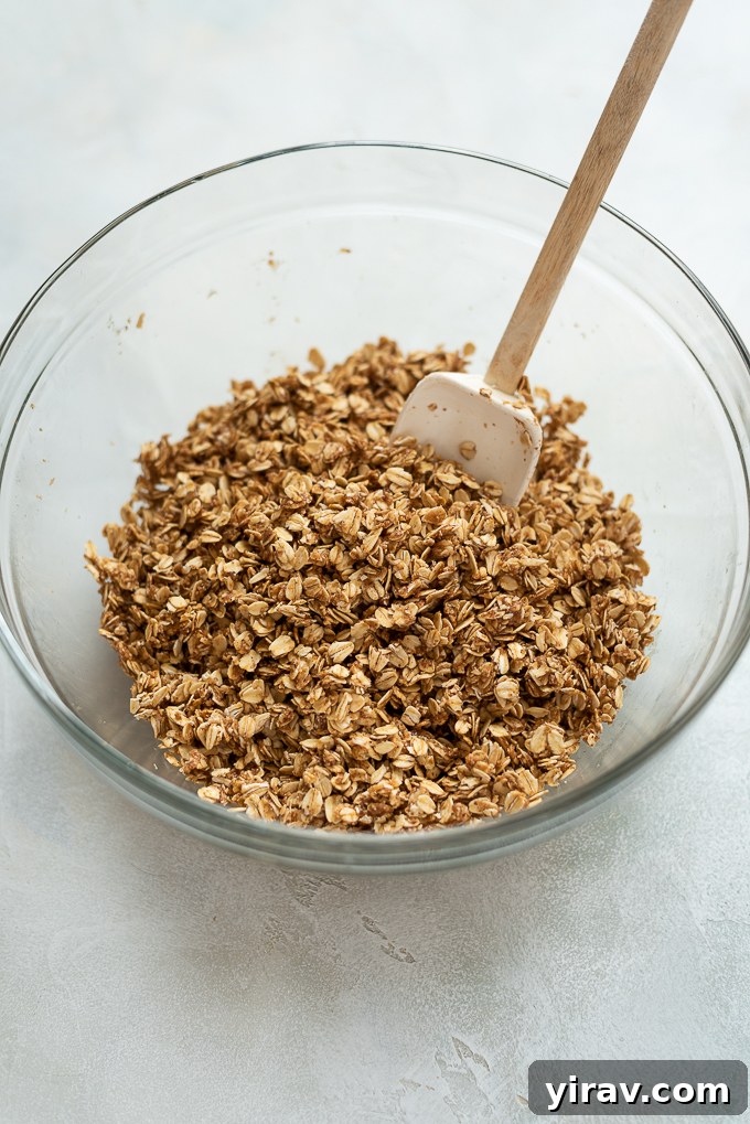 Step 2: Almond butter granola mixture in mixing bowl before baking with oats added.
