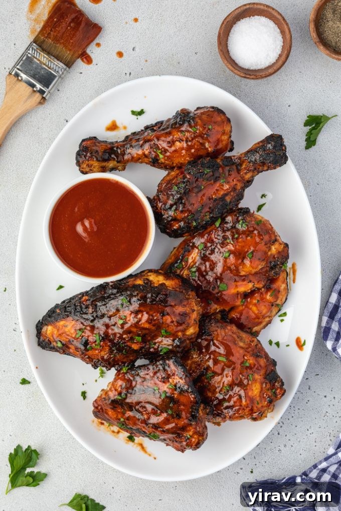 Grilled barbecue chicken on a serving platter with sauce