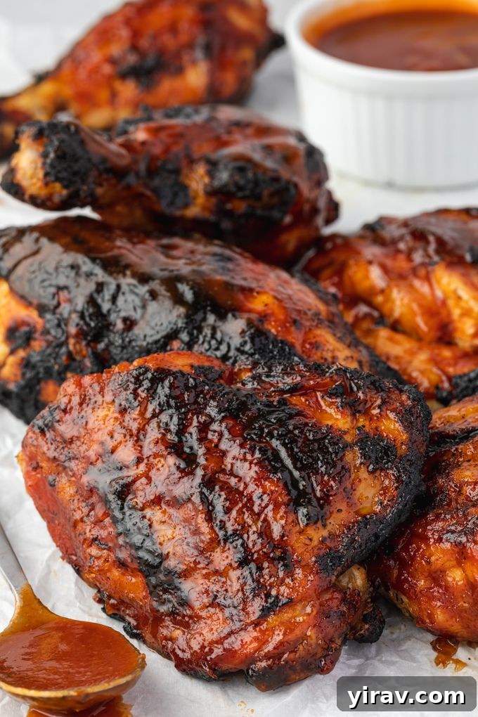 Grilled barbecue chicken on a platter with sauce