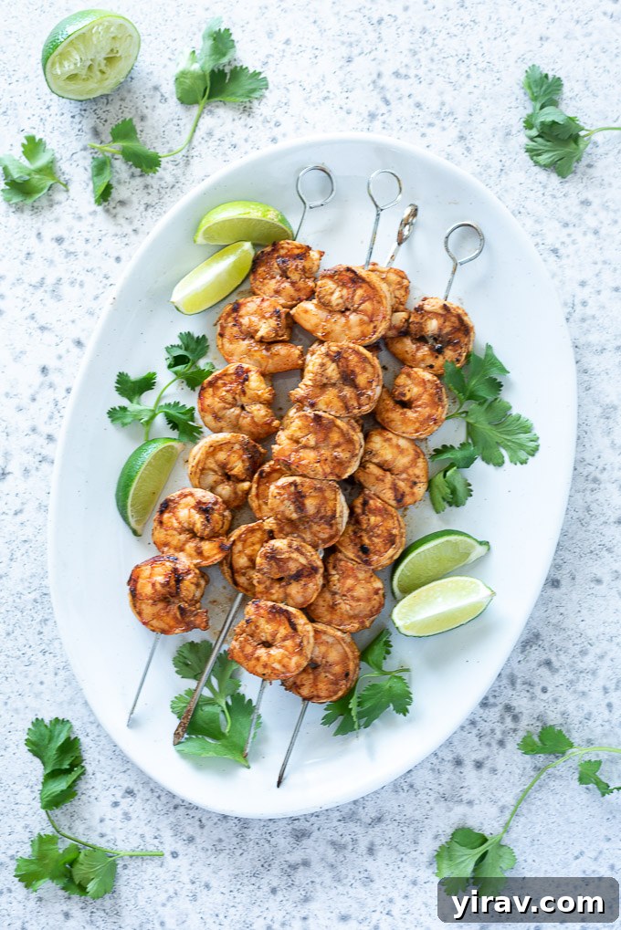 Platter of grilled shrimp skewers with lime and cilantro