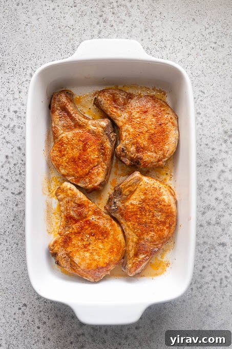 Tender Oven Baked Pork Chops 8 Baked bone-in pork chops in baking dish.