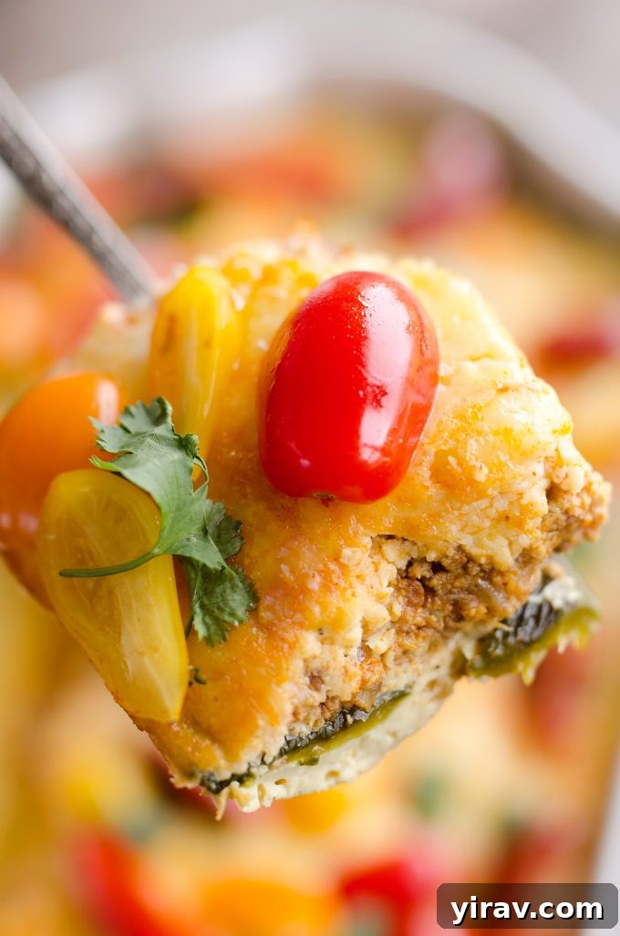 A delectable slice of Roasted Poblano & Chorizo Egg Casserole being served, showcasing its layers.