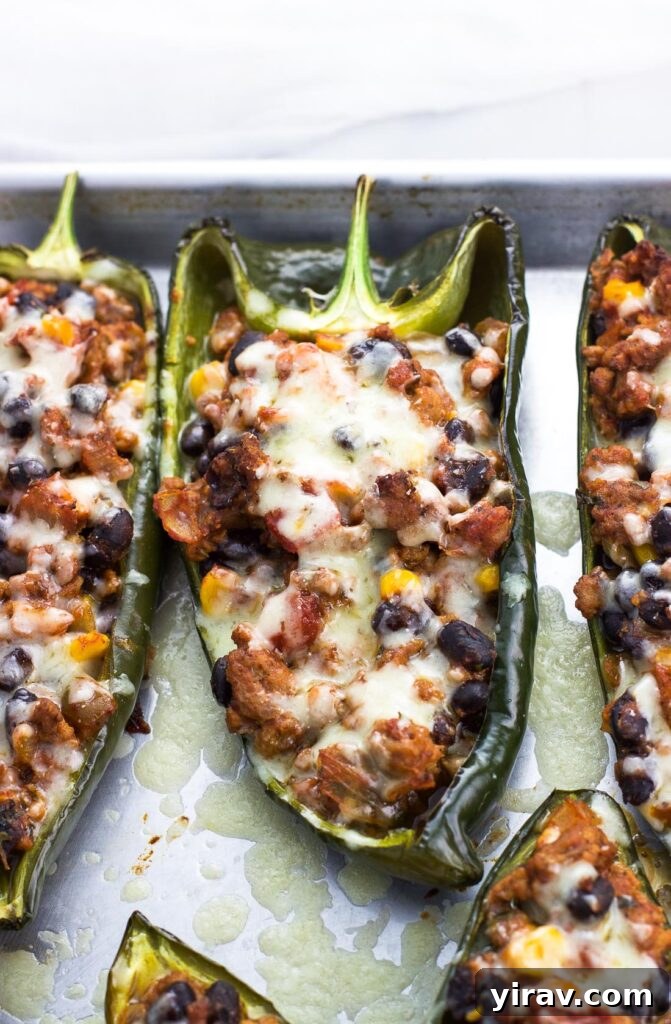 Healthy stuffed poblano peppers baking on a tray, looking appetizing and ready to be served.