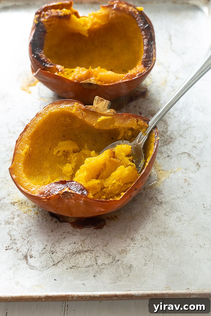 Effortlessly Make Your Own Pumpkin Puree 7 Spoon scooping roasted pumpkin
