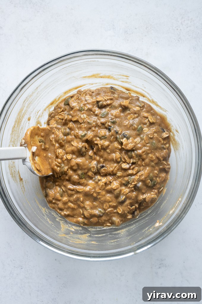 Pumpkin Spice Sunrise Bites 5 Pumpkin breakfast cookies batter with mix-ins in a mixing bowl.