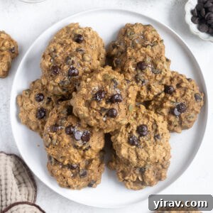Pumpkin breakfast cookies piled on a white plate, ready to be served.