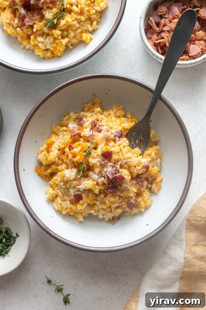 Velvety Pumpkin Risotto 7 A bowl of pumpkin risotto with crispy bacon and a sprig of thyme, ready to eat.