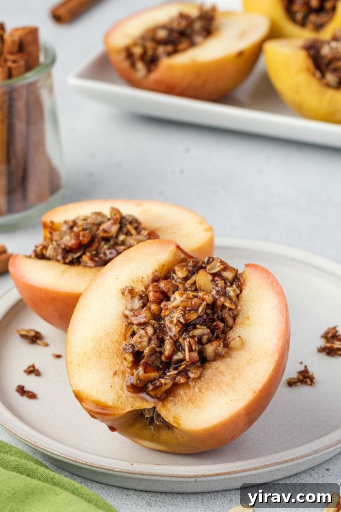 Baked Apple Bliss 7 A baked apple cut in half, showcasing its rich oat pecan filling and caramelized interior.