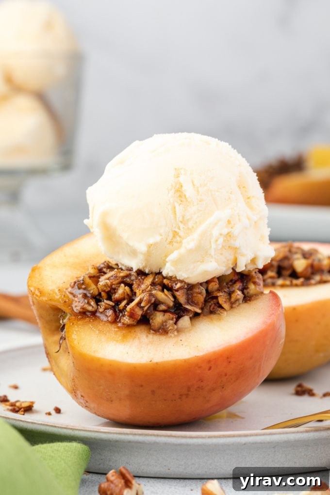 Baked Apple Bliss 8 A plate featuring a halved baked apple with ice cream, ready to be enjoyed as a delightful dessert.