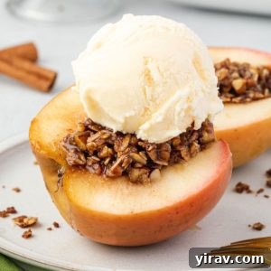Baked apples cut on a plate with ice cream