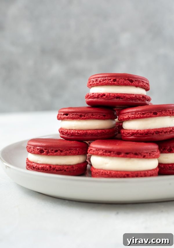 plate of red velvet macarons stacked up
