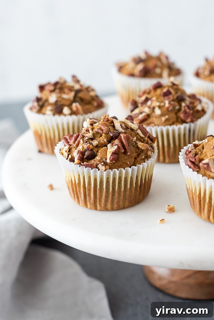 Pumpkin oat muffins on a pedestal server, beautifully arranged for serving.
